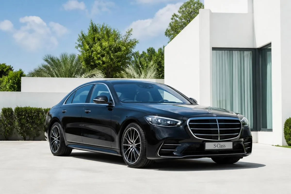 Black Mercedes-Benz S-Class first class sedan at a hotel entrance